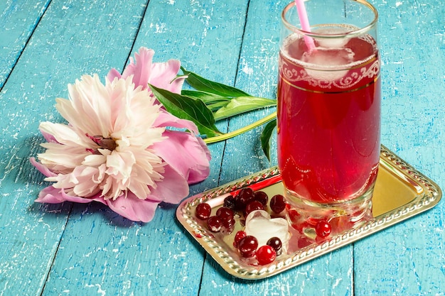 Peony and a cold drink with cranberry juice and ice