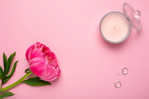 Peony flower, candle and rings. Happy valentines day background