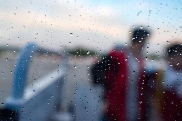 People after airplane window on rainy day