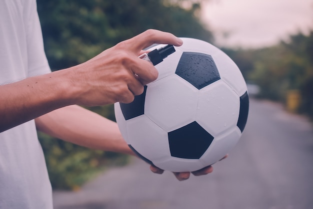 People alcohol spray cleaning soccer football