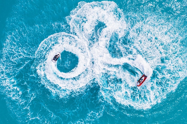 People are playing a jet ski in the sea Aerial view Top view amazing nature background Adventure