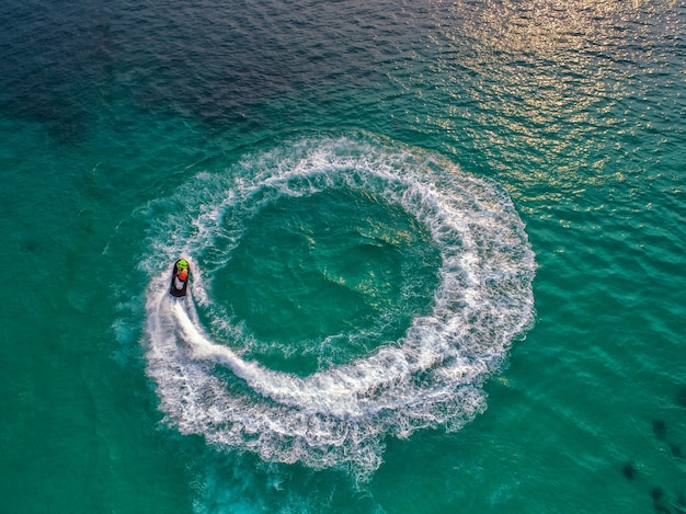 People are playing jet ski at sea during the holidays. 