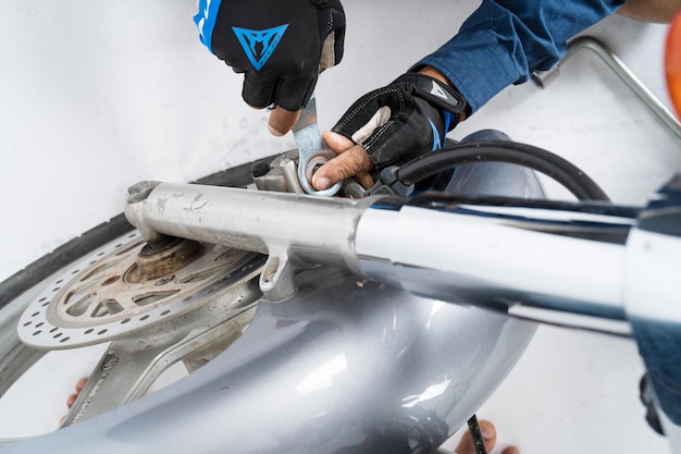 People are repairing a motorcycle Use a wrench and a screwdriver to work