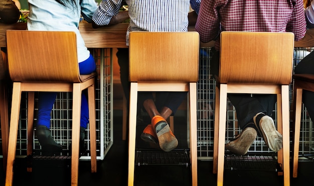 People are sitting on the bar stool