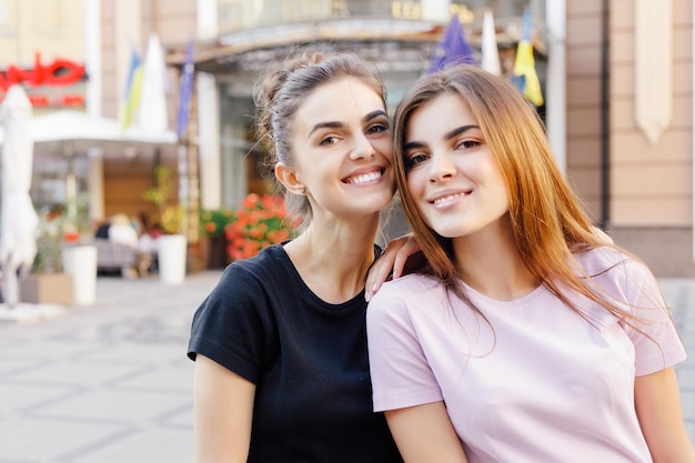 People beauty fashion lifestyle and color concept  Outdoor full body portrait of young beautiful happy smiling girl posing on street Model looking at camera smiling girlfriends having fun