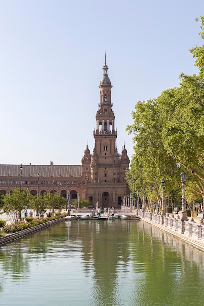 People boarding the boats at the pier of the pond in the Plaza de Espana in Seville Spain