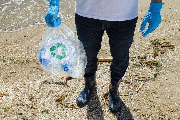 People clean up garbage on the banks of the river environmental protection