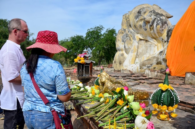 People come to Wat Lokayasutharam Temple for travel and pray Reclining Buddha on January 10 2016 in Ayutthaya Thailand