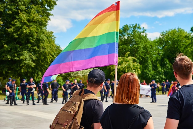 People crowd with LGBTQ rainbow flags on pride demonstration