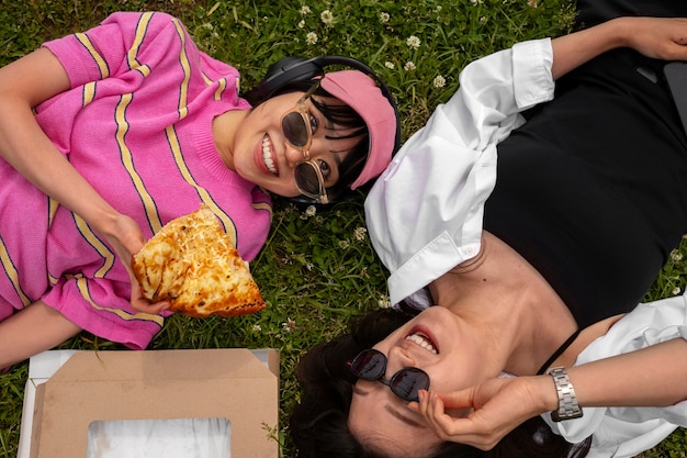 People enjoying pizza together outdoors