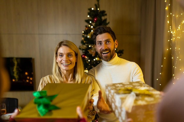 People family welcomes guests on christmas day eve dinner giving gifts to each other greeting on new