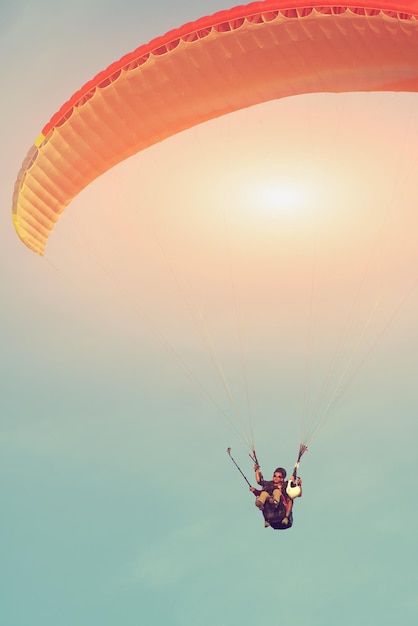 People flying a paraglider in the sky