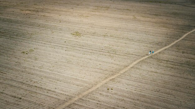 People go on the field aerial photography with a drone