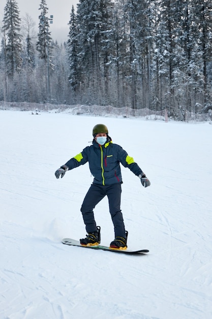 People go snowboarding and skiing, winter recreation and sports. Skiing down the mountain on a snowboard, funny emotions on the faces of men and women