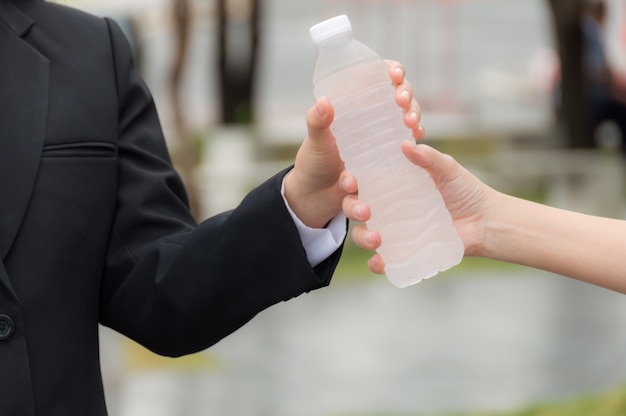 People handed out bottles of drinking water to friends.