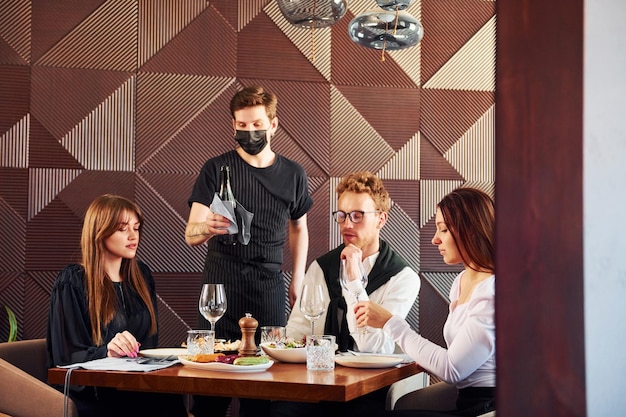 People have a dinner together Indoors of new modern luxury restaurant