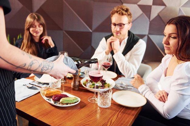 People have a dinner together Indoors of new modern luxury restaurant