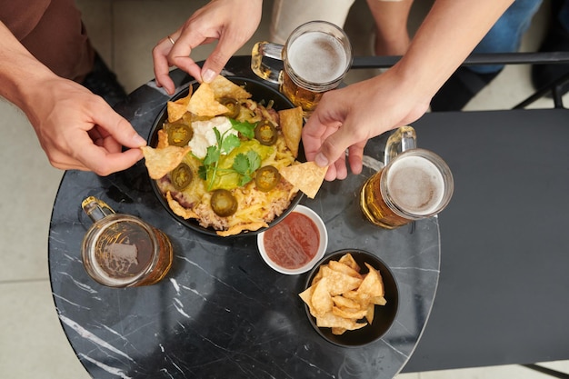 People Having Beers with Mexican Snack