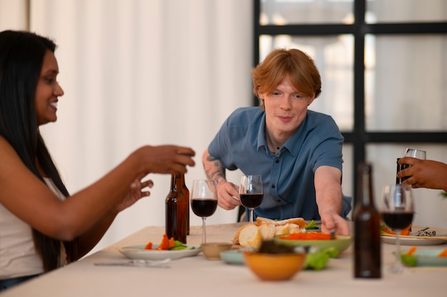 People having food and drinks at a dinner party