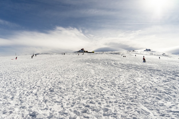 People having fun in snowed mountains in Sierra Nevada