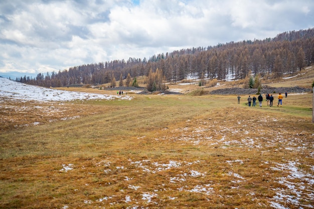 People on historic kurgan or tumulus grave mound in tschuja steppes altai republic siberia russia