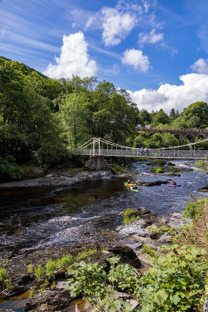 People kayaking by the Chainbridge in Berwyn, Wales