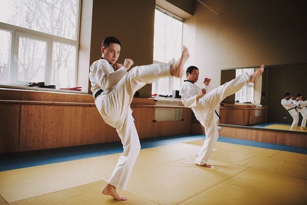 People in kimono working out racks with mma.