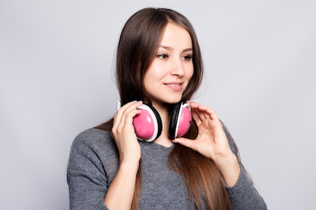 People leisure and technology concept happy woman or teenage girl in headphones listening to music from smartphone and dancing