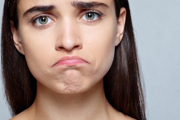 People, luxury and fashion, emotions concept - Portrait of young woman with shocked expression of sadness