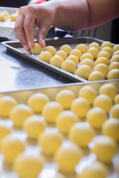 People make dough of nastar on a tray