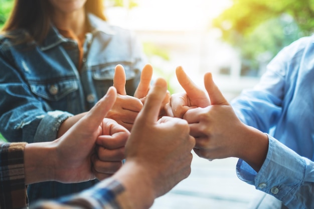 People making thumb up hands sign in circle