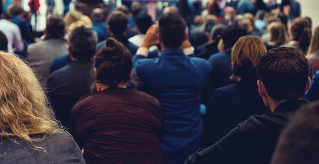 People on a meeting listen to the speaker, rear view. ideal for websites and magazines layouts