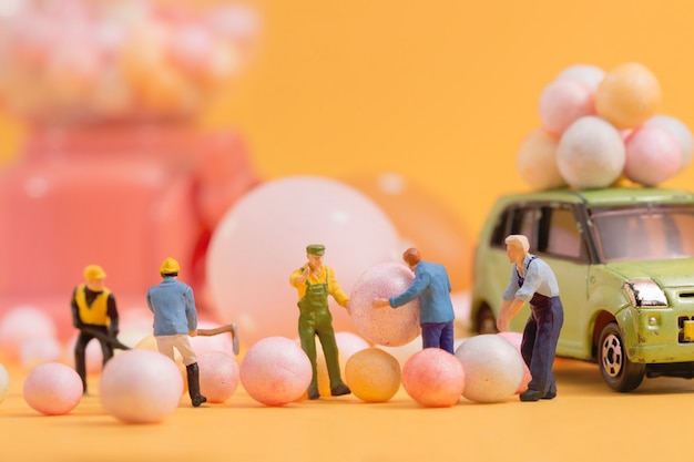 People(miniature) preparing Easter holiday  of Egg toy vending machine.Selective focus composition and soft pastel color toned.Easter 