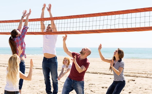 People play volleyball on beach