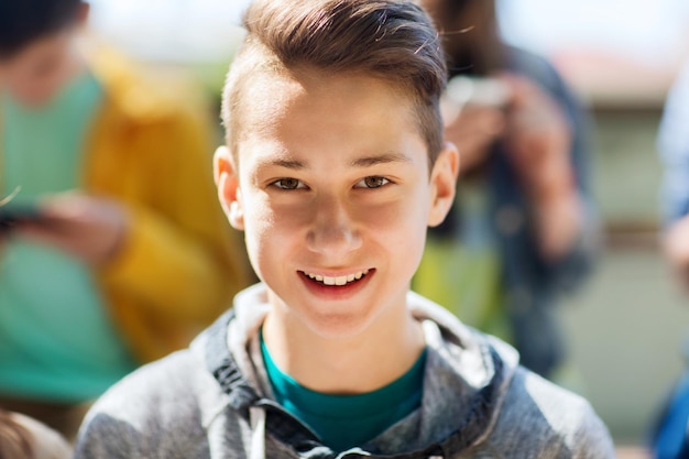 people and portrait concept - happy teenage boy face