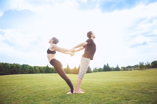 People practice acro yoga outdoors healthy lifestyle