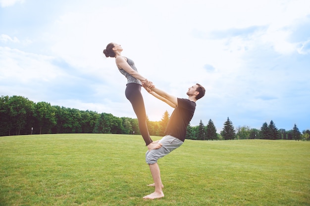 People practice acro yoga outdoors healthy lifestyle