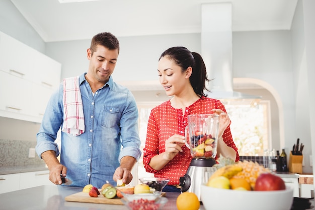 People preparing fruit milkshake