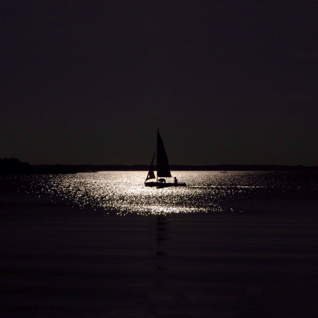 People sailing in sea at night