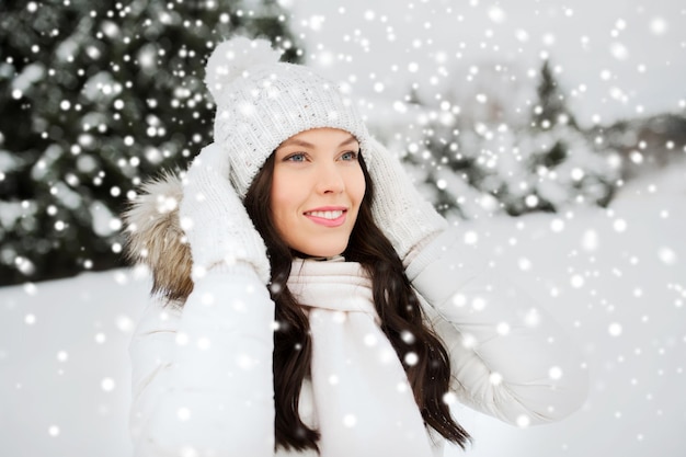 people, season and leisure concept - happy woman outdoors in winter clothes