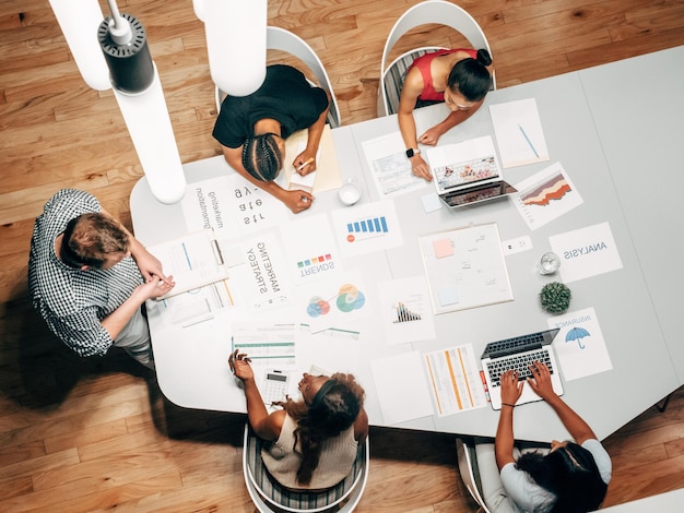 people sitting around a table with a chart that saysbusinesson it