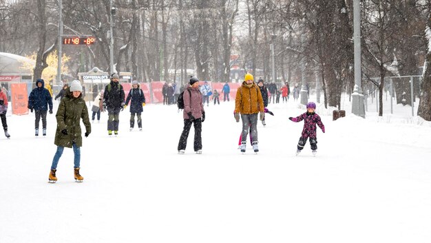 People skating on the rink at the Sokolniki park during winter day in Moscow