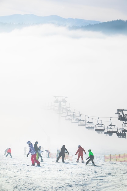 People on the ski slope learning to ride families winter resort