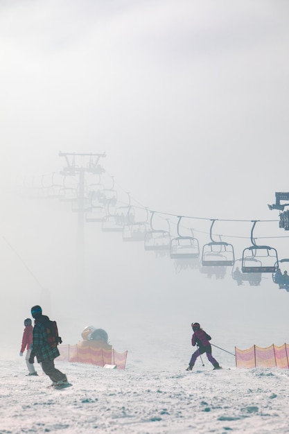 People on the ski slope learning to ride families winter resort