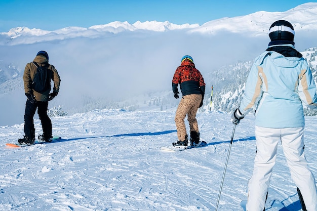 People skiing and snowbording in Zillertal Arena ski resort in Tyrol in Mayrhofen in Austria in winter Alps. Skiers in Alpine mountains with white snow and blue sky. Austrian snowy slopes