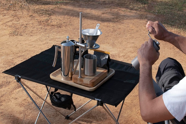 People sltting on a chai grinding coffee by hand, for drip coffee,to travel and drip coffee concept