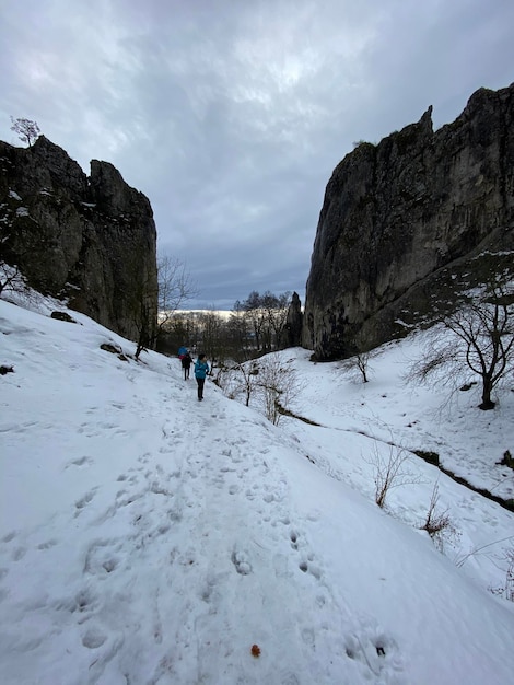 People on snow covered mountain against sky