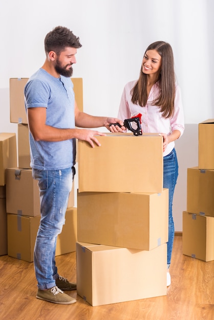 People stand near boxes and unpack boxes.