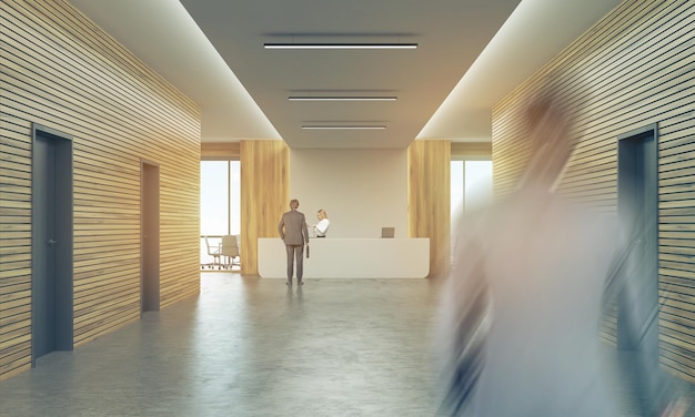 People in sunlit office corridor with reception counter