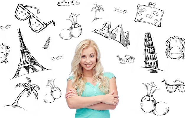 people, tourism, vacation and summer holidays concept - happy smiling young woman or teenage girl over touristic doodles